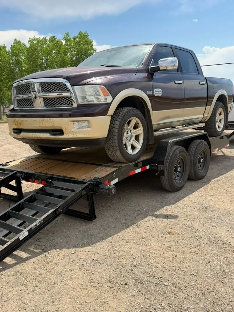 Pickup truck loaded on a car hauler trailer rental