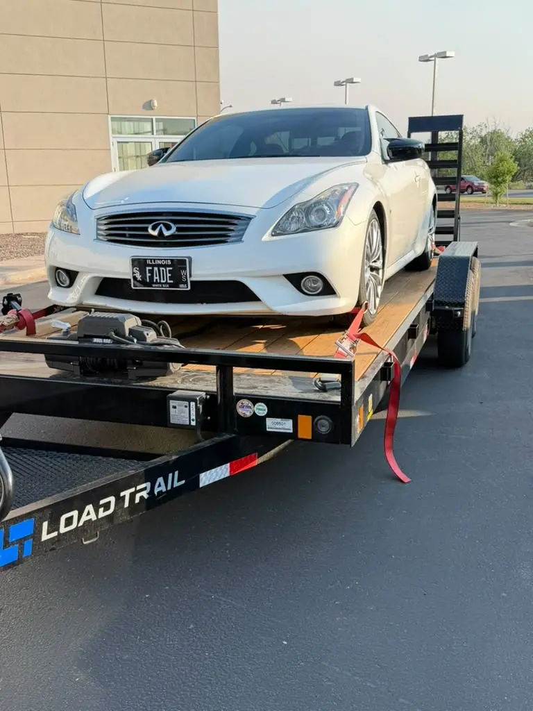Sports car secured on a car hauler trailer