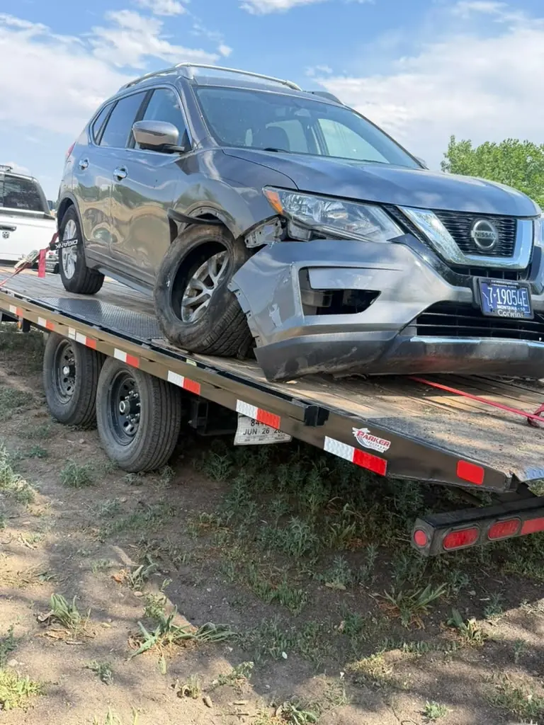 Damaged SUV on a vehicle transport trailer