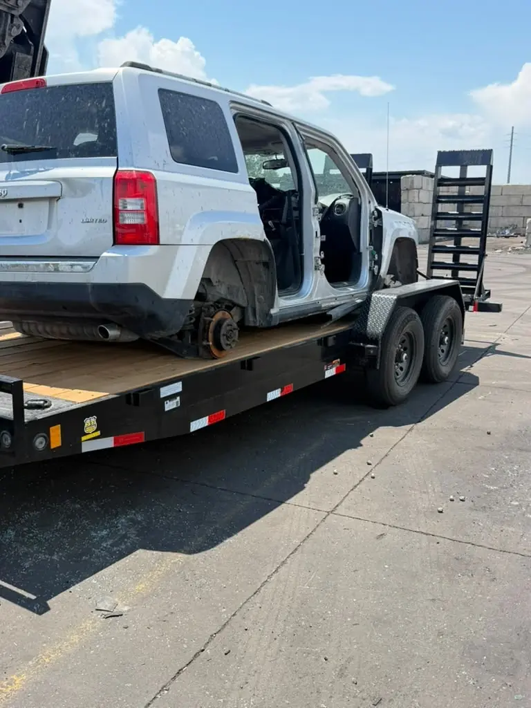 Disabled SUV transported on a car hauler trailer